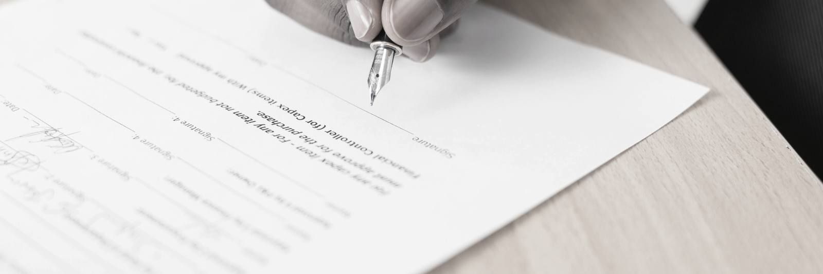 Main écrivant sur une feuille blanche